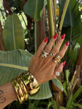 Natural background with female hand showcasing ODL rings and bracelets